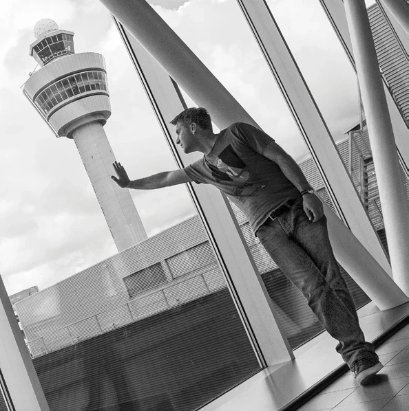 Viktor Juriga beside an airport control tower.